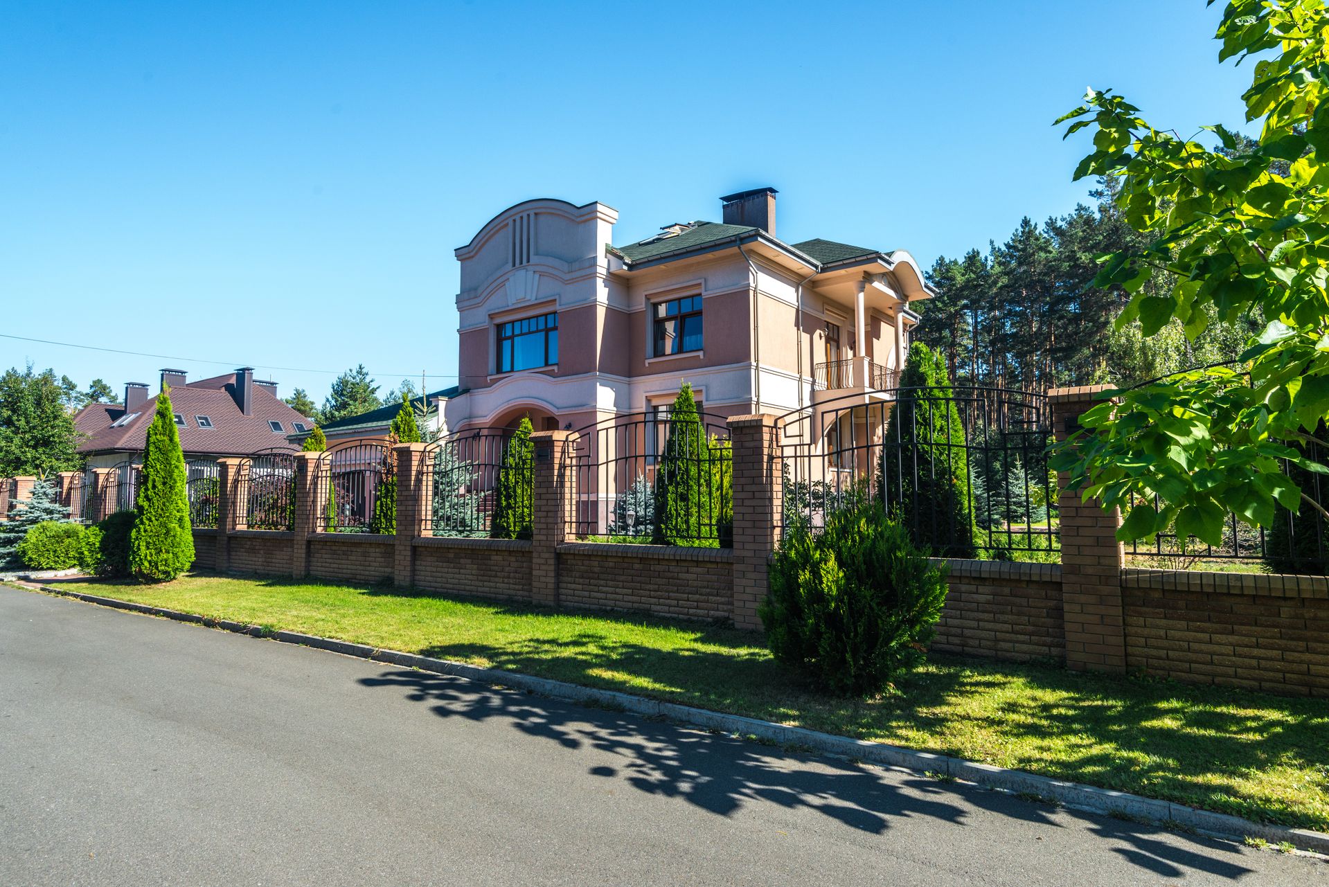 Modern residential fence combining solid privacy panels with clean metal details