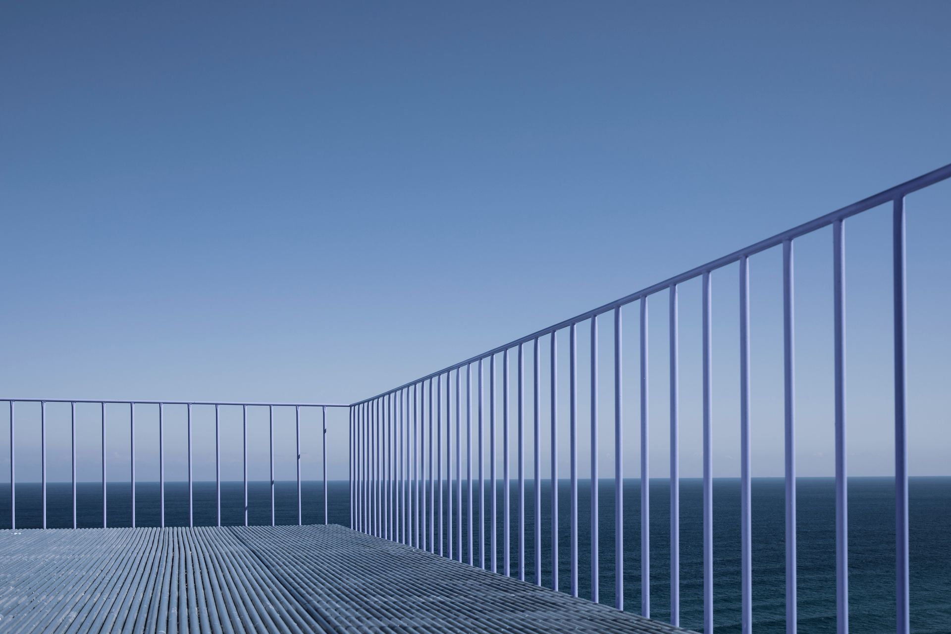 Modern residential deck with dark metal railing overlooking an outdoor space