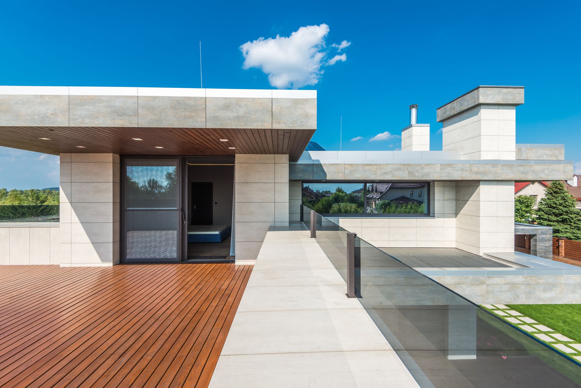Clear glass railing surrounding a modern residential outdoor deck