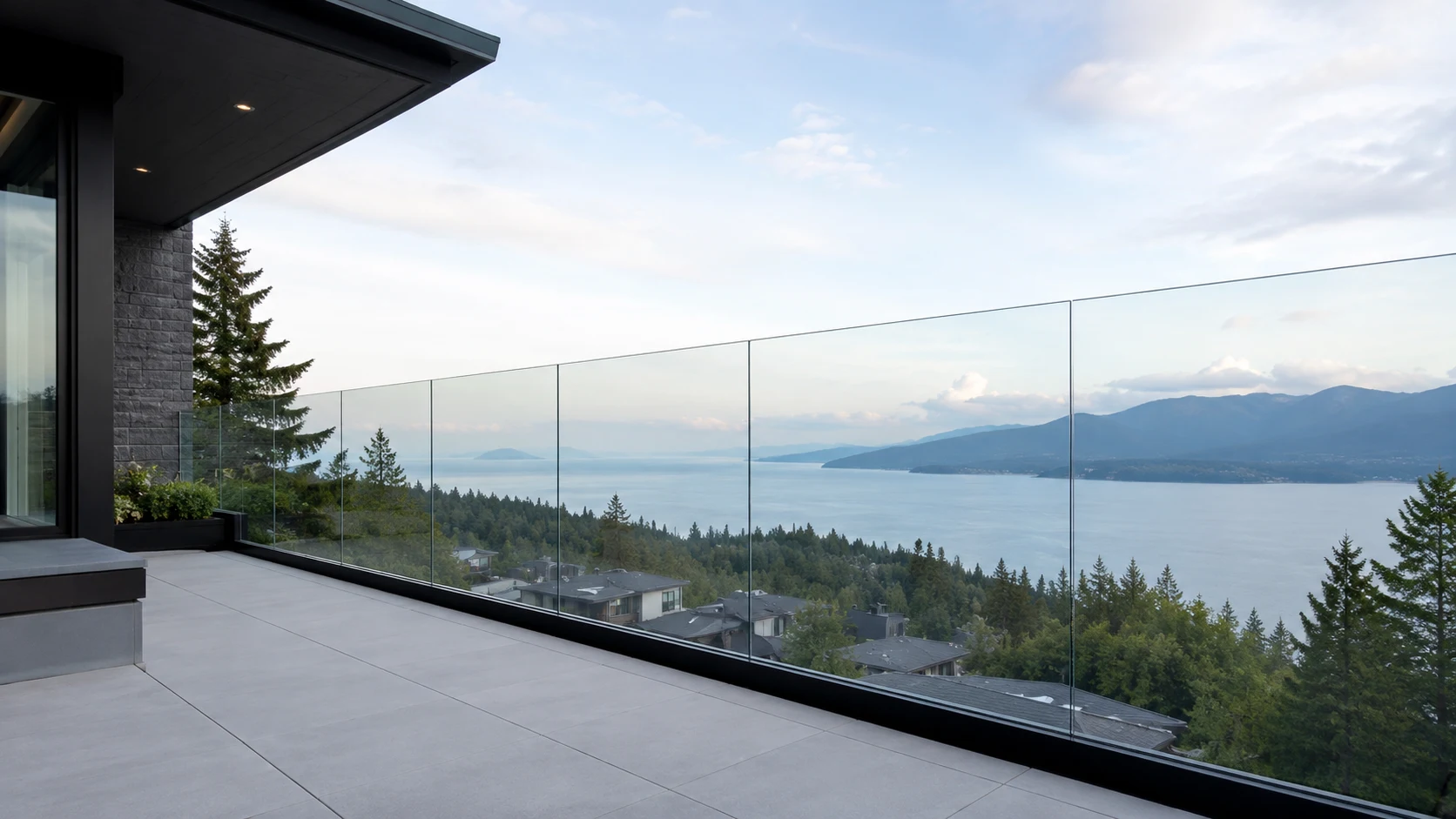 Frameless glass railing on a Metro Vancouver home overlooking the mountains and ocean