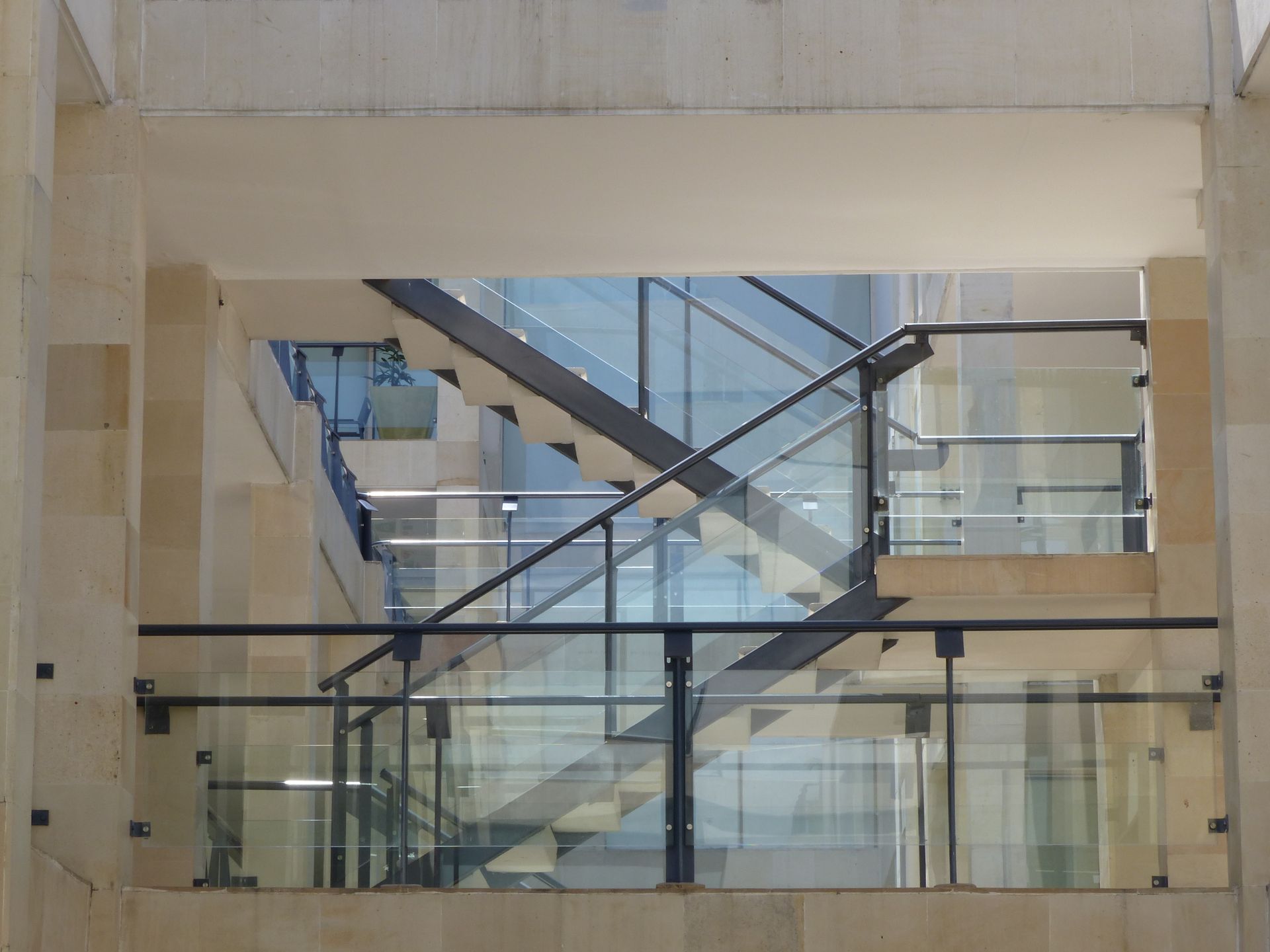 Clear glass railing panels with minimal metal hardware on a modern deck